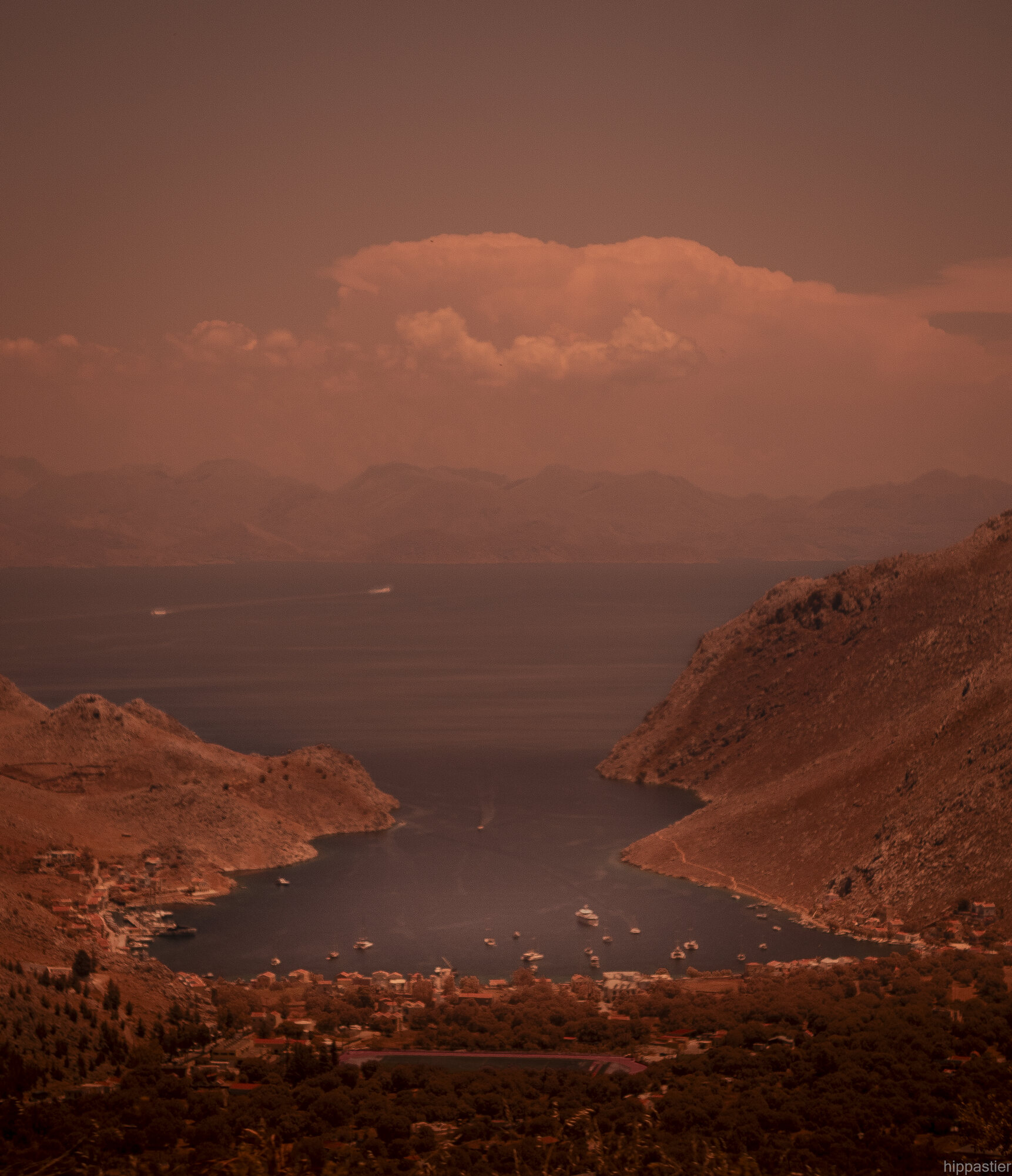 Harbour bay seen from mountainside, infrared haze, boats at anchor
