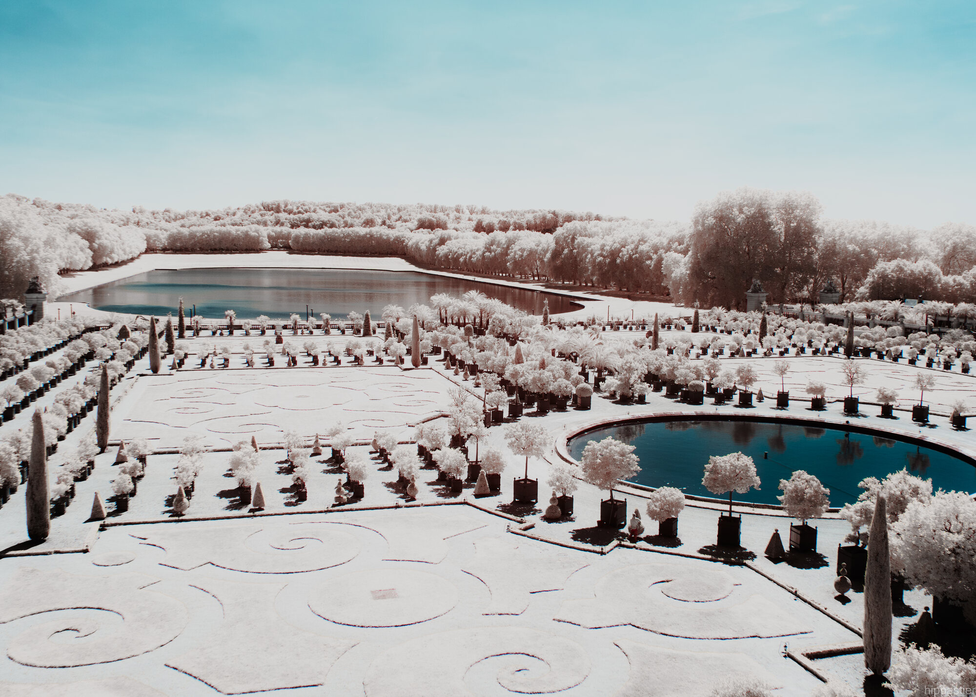 Orangerie garden at Versailles from above, infrared white parterres and blue sky