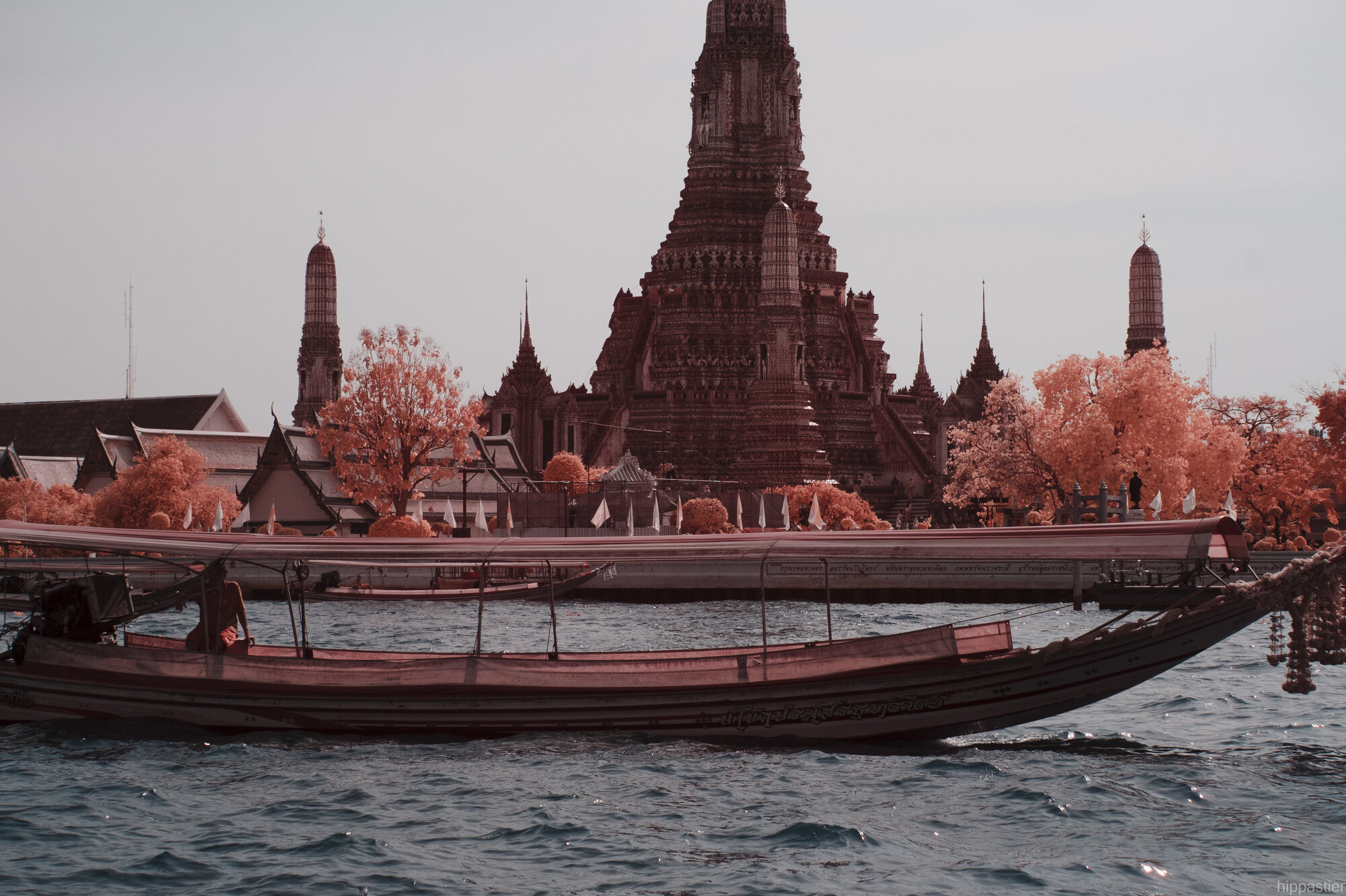 Wat Arun temple in Bangkok, shot in infrared, rendered in salmon and rose tones
